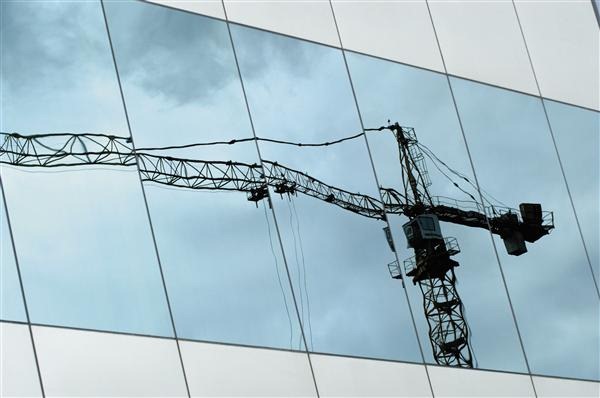 Low Angie View of Crane Reflected on Window